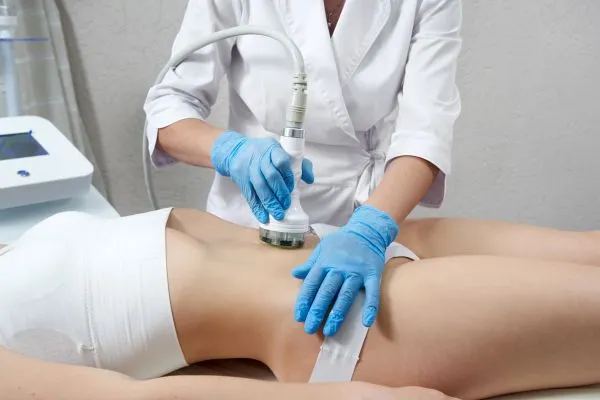 Lost the Weight but Not the Loose Skin? 2 woman having HIFU treatment on her stomach to combat loose skin Cambourne following weight loss